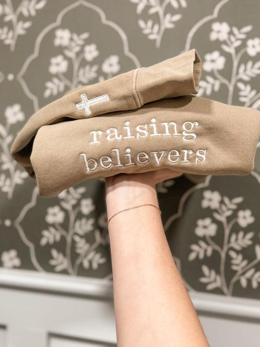 raising believers tan crewneck with cross sleeve